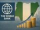 Illustration of the World Bank logo beside a map of Nigeria with rising coins and an upward financial chart, symbolising growing revenue collection costs in Nigeria.